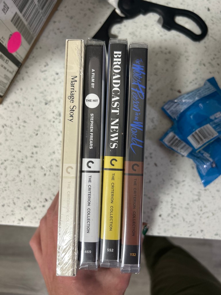 a photo showing the spines of four Criterion films: Marriage Story, The Hit, Broadcast News, and The Worst Person in the World.